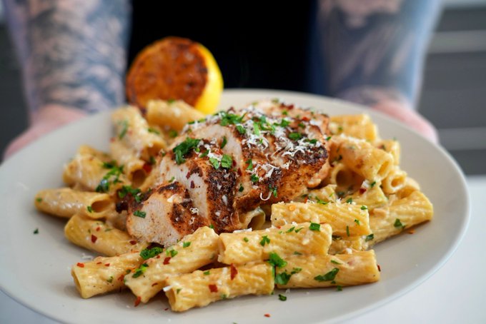 A plate of Lemon Butter Pasta topped with parsley and Parmesan.